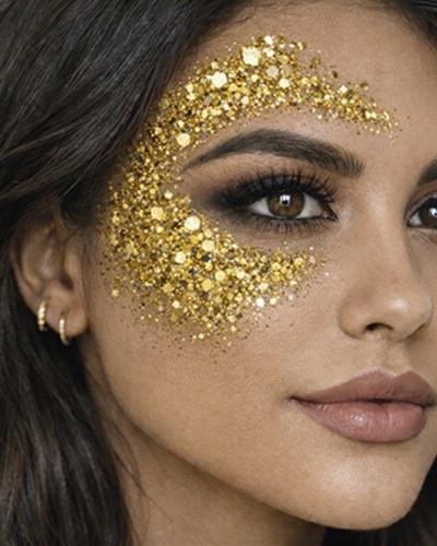 Bâton de maquillage à paillettes dorées